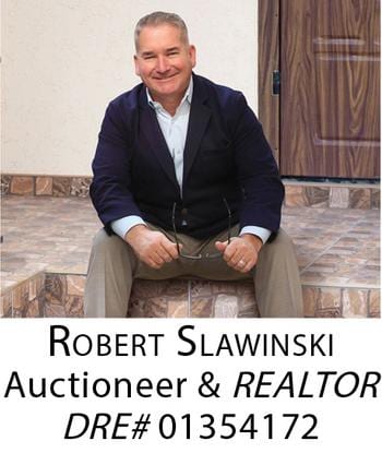 A man sitting on the steps of an estate sale.