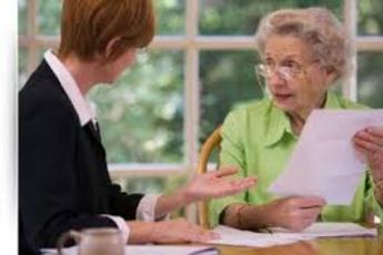 A woman and an older person are talking at the table