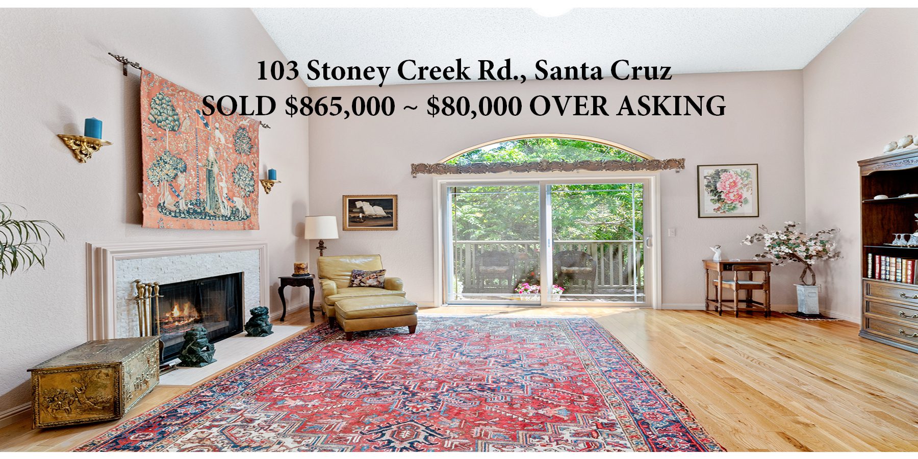 A living room with a large rug and fireplace.