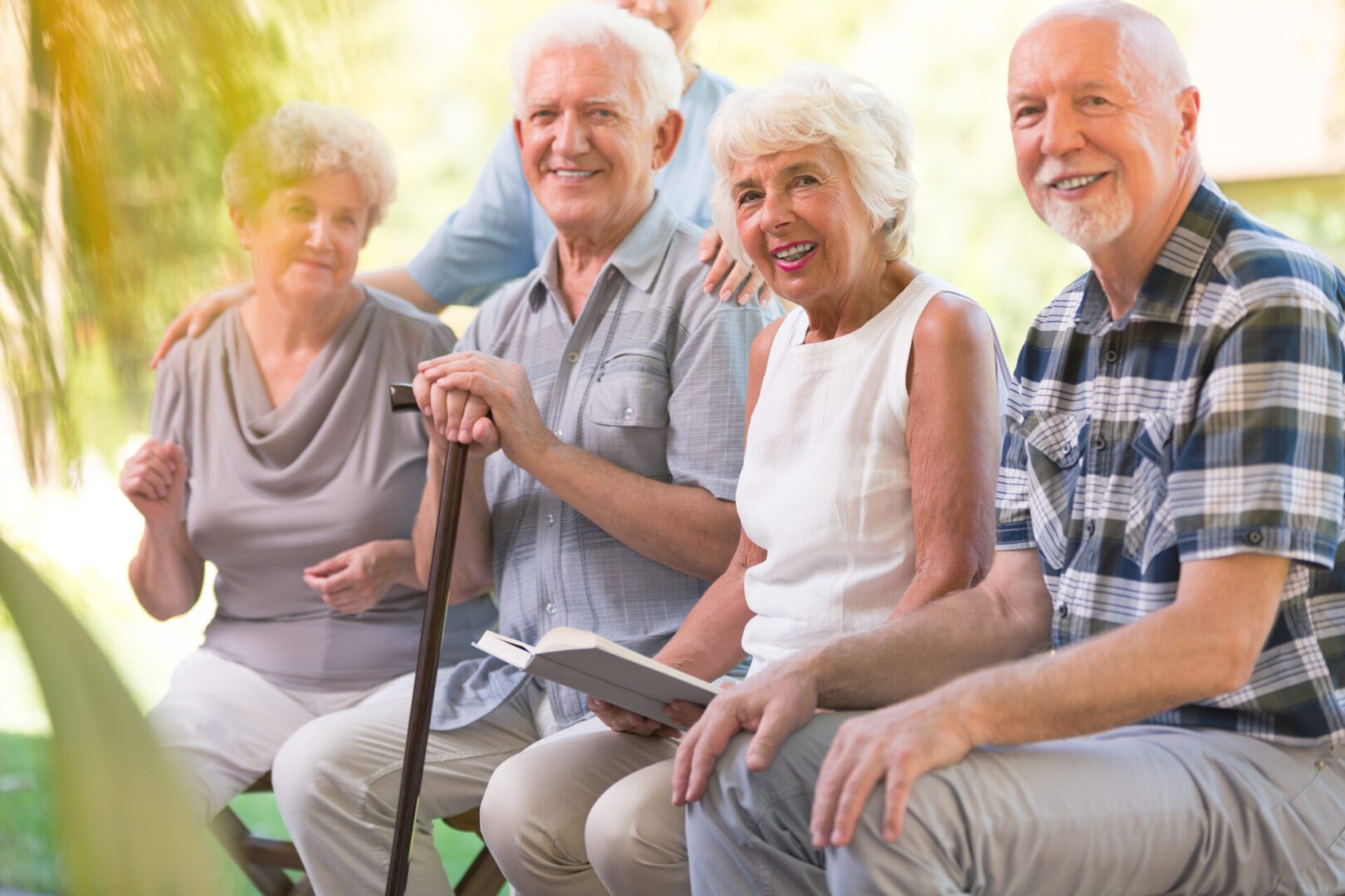 A group of people sitting on top of a bench.