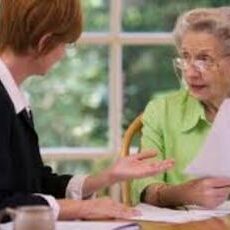 A woman and an older person are talking at the table