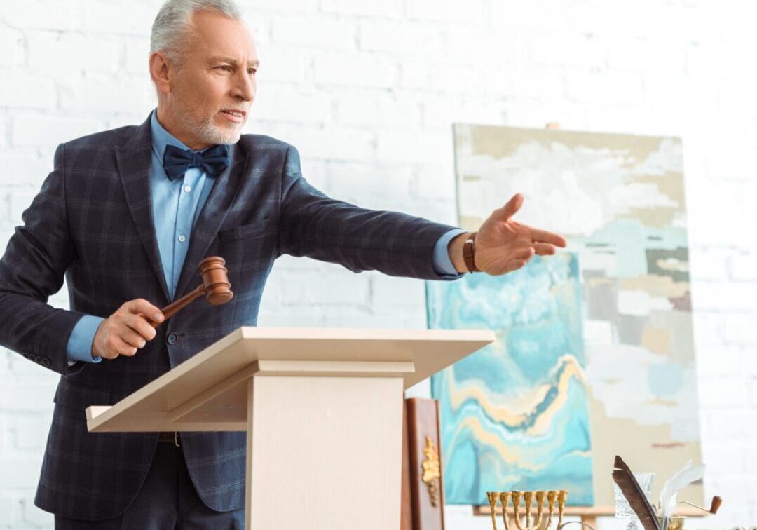 A man in a suit giving a speech at a podium.